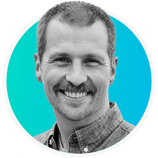 A man with a mustache smiling in a circle.